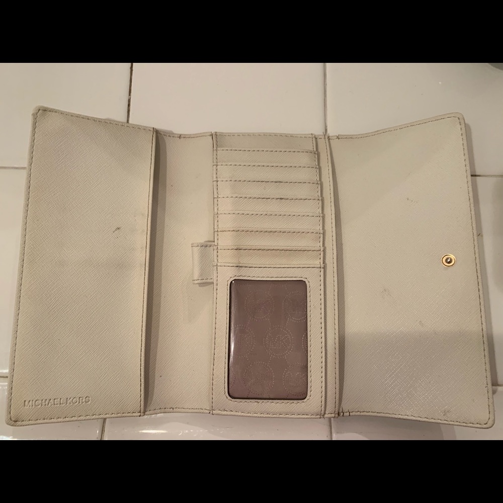 Cream Micheal Kors wallet and check book holder.
